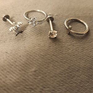 Set up four silver colored piercings